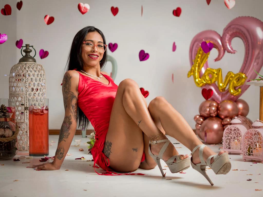 EmmaaGarcia is wearing a short red dress