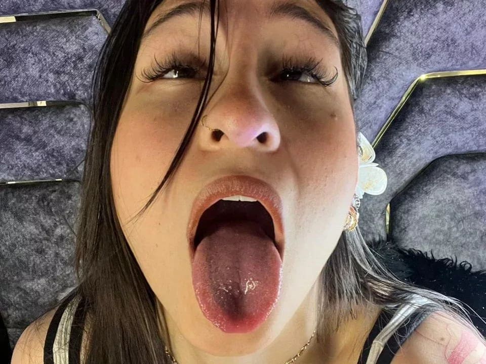 MaddyCarina: tight skirt play, black tank top, tongue out, high-contrast